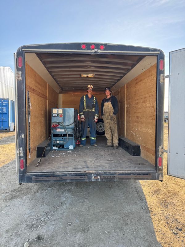 Leighton and Denim with L&D's Krendl machine and generator inside the enclosed trailer